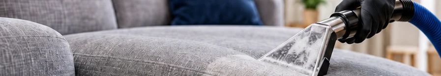 Handheld cleaning tool on a fabric sofa
